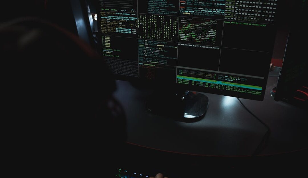 Dark room setup with code displayed on PC monitors highlighting cybersecurity themes.