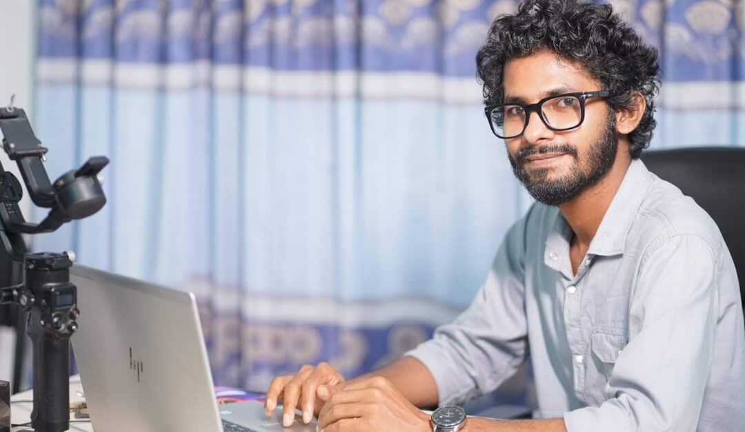 Portrait of a web developer working on a laptop, showcasing technical and professional skills.