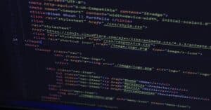 High-resolution close-up of HTML code displayed on a computer screen, perfect for technology themes.