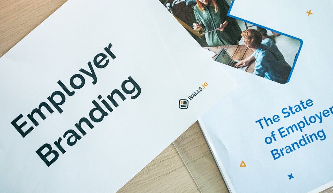 Flat lay of employer branding materials on an office table, showcasing marketing and design.