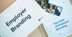 Flat lay of employer branding materials on an office table, showcasing marketing and design.