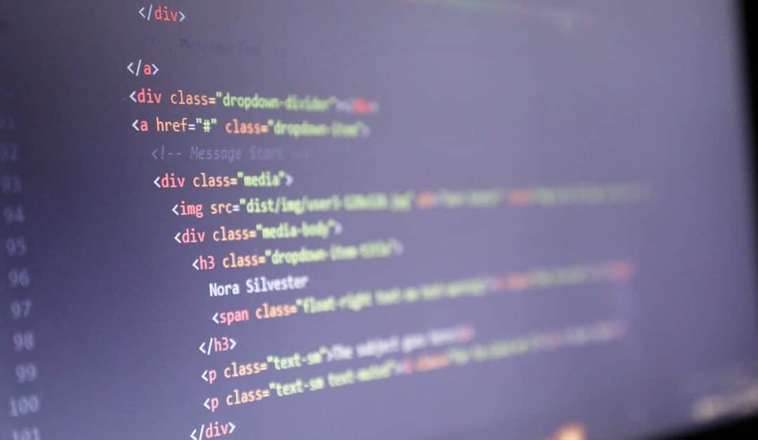 Illuminated HTML code displayed on a computer screen, close-up view.