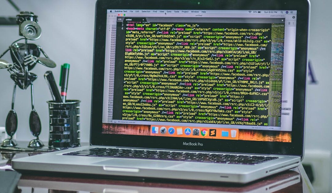 A sleek MacBook Pro displaying code on a desk with office tools and creative decorations.