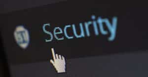 Close-up view of a mouse cursor over digital security text on display.
